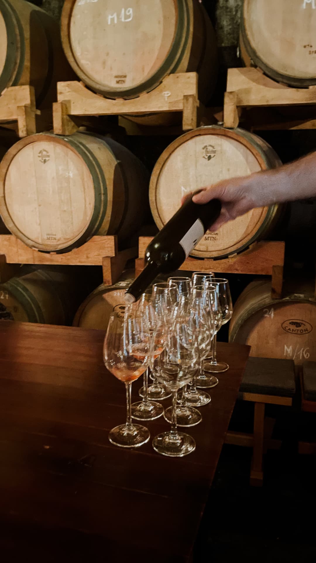 Wine being poured in a barrel room at a Livermore Valley winery